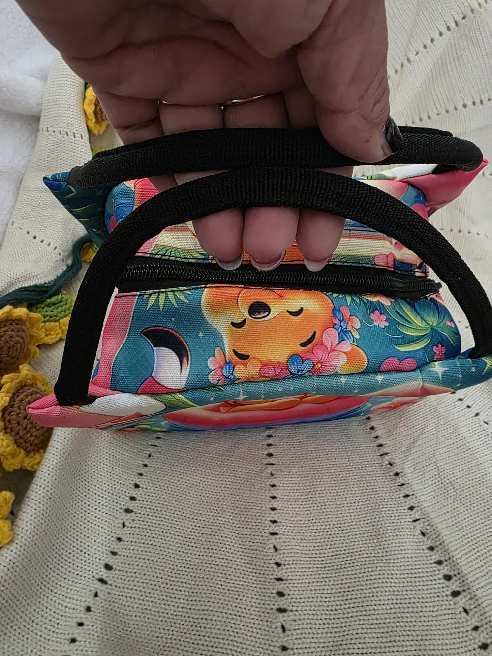 Insulated lunch bag features a playful design of Winnie the Pooh wearing a color